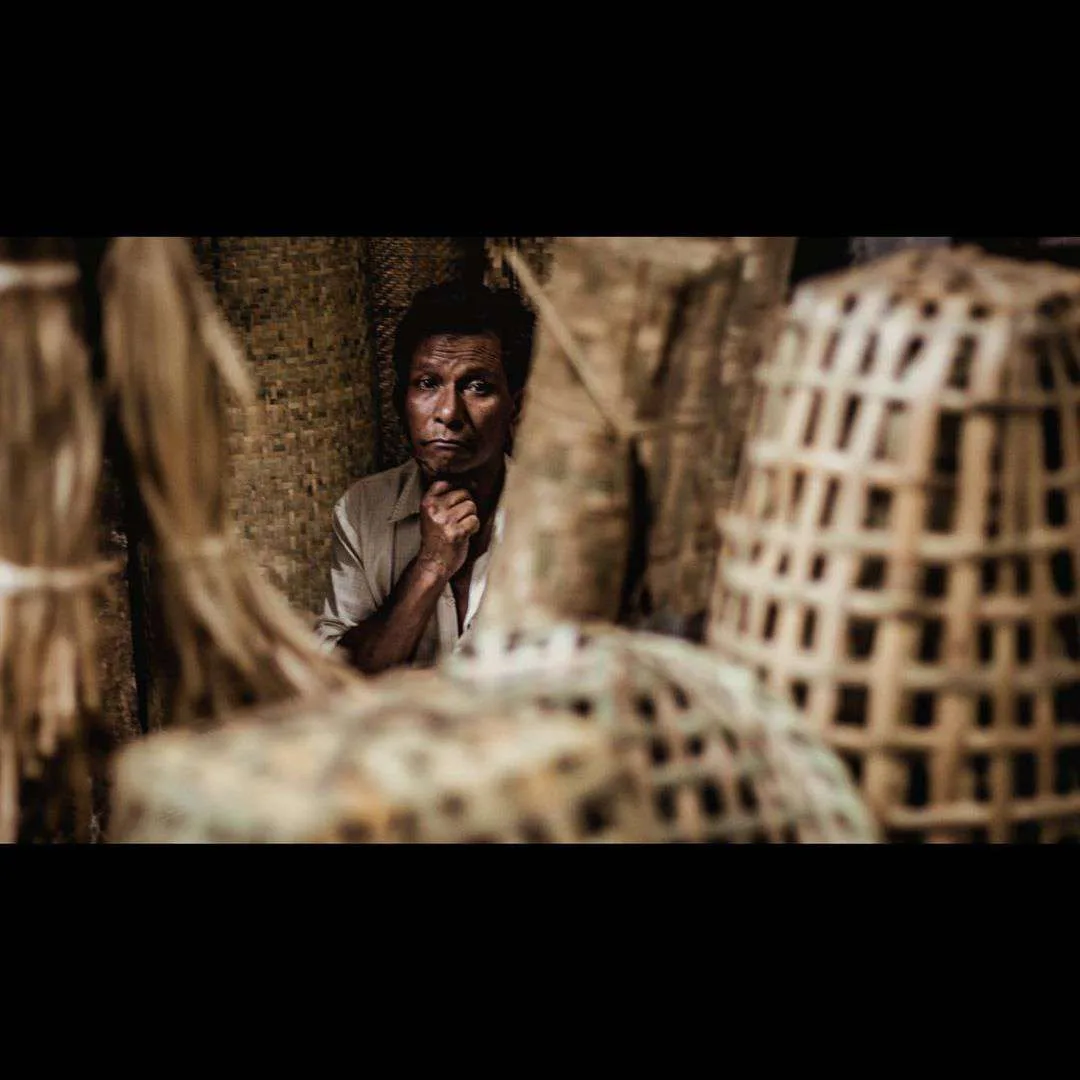 A weaver behind his bamboo baskets