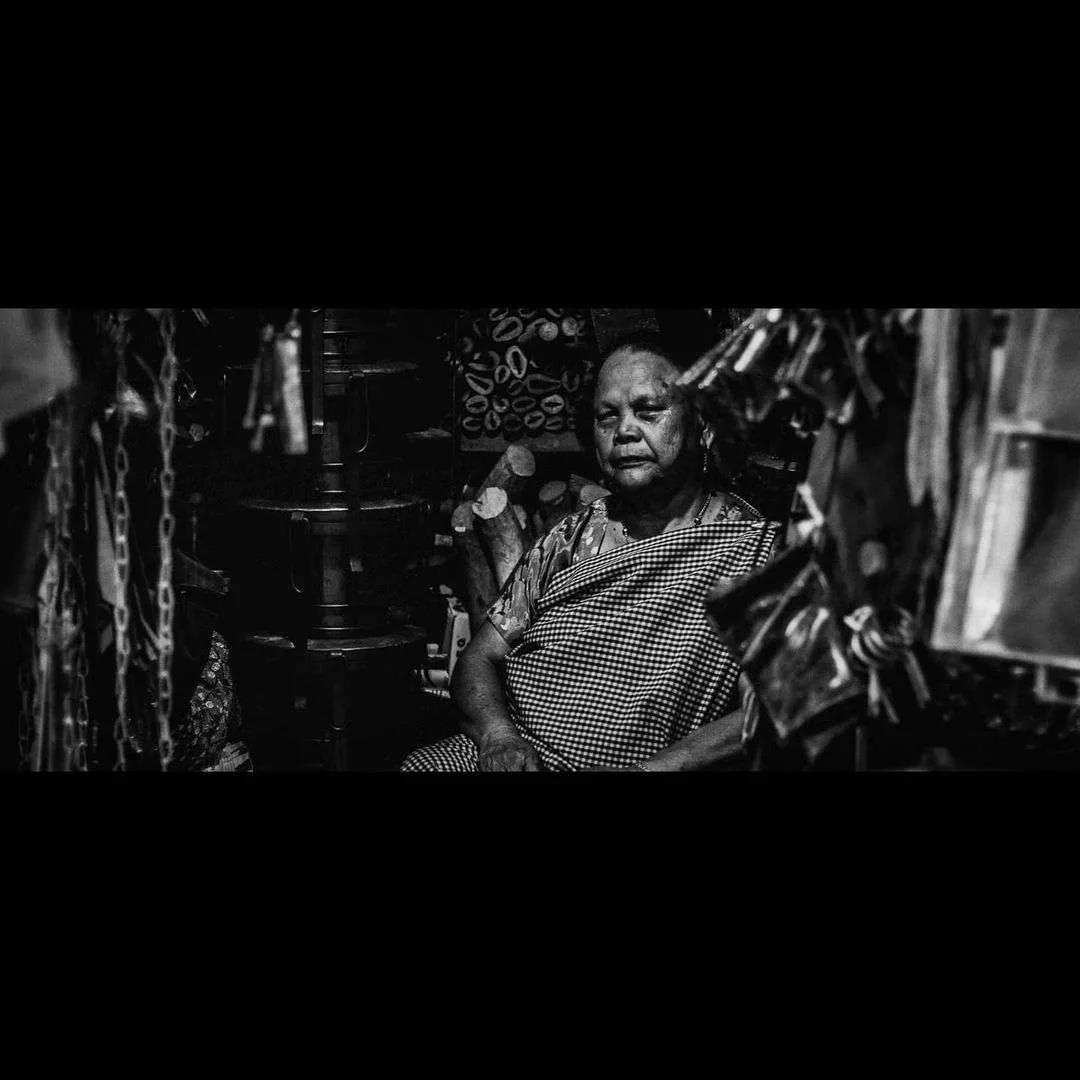 A vendor watching the market from inside her stall