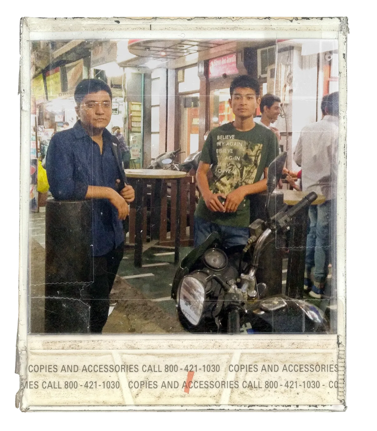 Sosa and Ashish at a Delhi market with a motorcycle